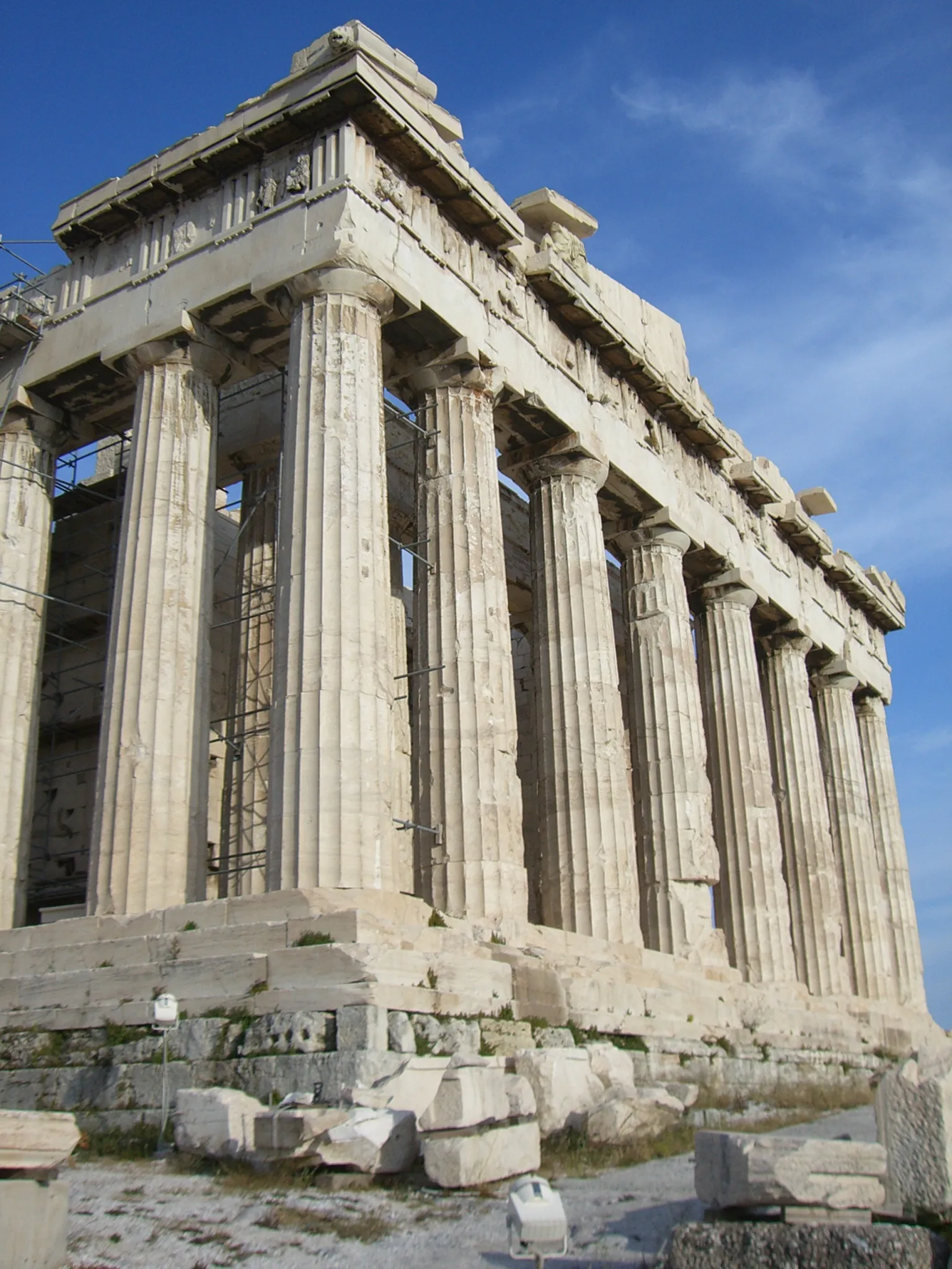 The Parthenon on the Acropolis in Athens, seen from below at its northwest corner, Doric columns rising against a blue sky