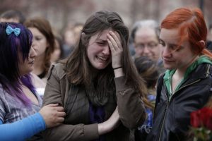 Emma MacDonald, 21, center, cries during a vigil for the victims of the Boston Marathon explosions at Boston Common, Tuesday, April 16, 2013. Twin explosions near the marathonís finish line Monday killed three people, wounded more than 170 and reawakened fears of terrorism. (AP Photo/Julio Cortez)     Emma MacDonald, 21, center, cries at a vigil for victims of the Boston Marathon bombings at Boston Common, April 16, 2013. (AP Photo/Julio Cortez)